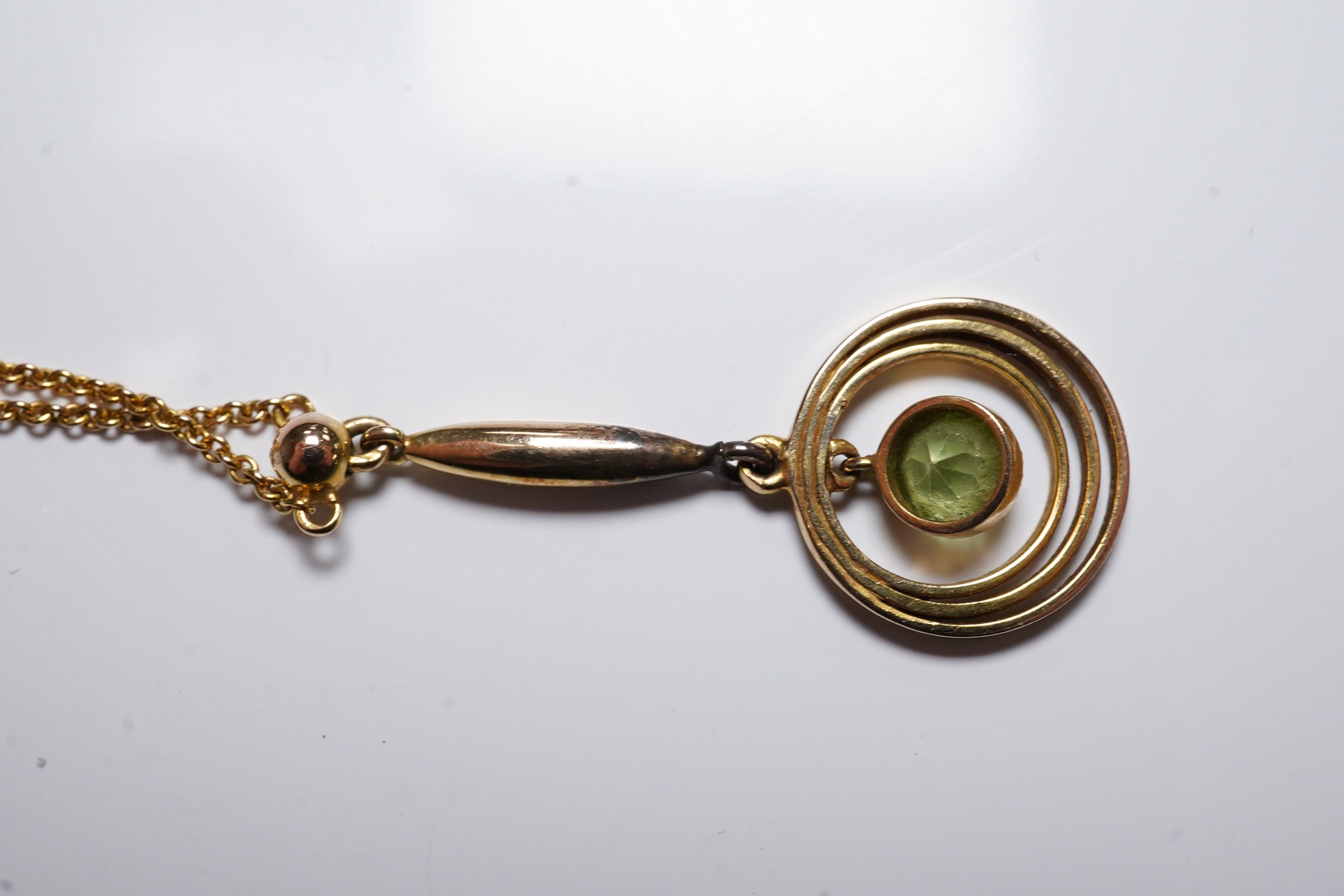 An Edwardian 9ct and peridot set drop pendant necklace, 47cm, gross weight 2.5 grams. Condition - fair to good